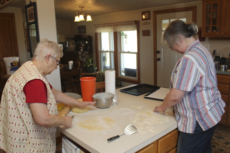 ["Eleanor Betler was born in Buckhannon, West Virginia in 1940 and raised in Cleveland, Ohio. She spent her summers in Helvetia at the farm of her maternal grandparents, James and Anna Merkli McNeal. She married Howard Bud Betler in 1961. The couple moved to a hilltop farm in Helvetia and raised four children. All the good cooks, many of them relatives of Mr. Betler taught Mrs. Betler about canning, preserving, cooking and baking. She was especially interested to learn the skills of butchering and preserving meat, and making sausage. Mrs. Betler loves the Swiss traditional baking but also Appalachian ways of some neighbors. She grinds her own flour for baking bread. At Fasnacht time she invites neighbors and friends to make the hozablatz and rosettes just to keep the tradition alive. She also preserves this history by collecting stories, music, and photographs for The Helvetia Archives.This interview is part of a series of interviews conducted with foodways practitioners in Helvetia, West Virginia, as part of the Helvetia Foodways Oral History Project in partnership with the Southern Foodways Alliance. Learn more: https://www.southernfoodways.org/oral-history/helvetia-west-virginia/"]%