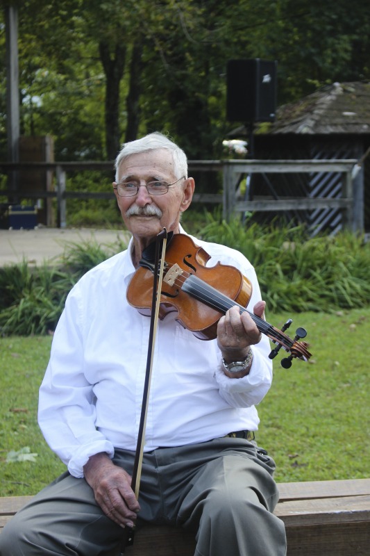 ["Vernon John Burky was born to a Swiss family in Helvetia, West Virginia in 1925. He grew up speaking Swiss on his family farm, where his parents raised animals and managed a sawmill, and his grandparents operated a cheese house. They made Helvetia cheese, a type of Swiss cheese, similar to Emental, that was made throughout the Helvetia community and a staple in the diet of residents. As a child, Burky raised chickens and tapped maple trees on his family farm. As an adult, he was an active winemaker, a common pursuit in the Helvetia community. During his working years, Burky worked as a truck driver for a saw mill and a coal company. He learned to play fiddle as a child and started playing in the Helvetia Star Band, the local dance band for generations and the namesake of one of the villages two dance halls. He still plays in the group, which performs regularly for Helvetia square dances and events. Yeah; just kept that smokehouse full of smoke all day and night. Theyd put a big hunk of wood on it; it wouldnt burn but it--they had fire under it and it would sit there and smoke that little room half as big as this. They just smoked up tight. They had the sausage on rods; nothing could come in or get up on there. There it would sit; it was just dried up real solid and my uncle was--I stayed with my uncle when I was in high school. And he said, hey Vernon; come over here. (Laughs) He had rheumatism and he couldnt move around. He was in bed all winter. Go up there to the smokehouse and get me a link of that sausage. (Laughs) And Id go up and clip one of them off and bring it down. Hed get a hold of one piece and put the rest under the pillow and hed start eating that. He wasnt supposed to have red meat because of rheumatism.This interview is part of a series of interviews conducted with foodways practitioners in Helvetia, West Virginia, as part of the Helvetia Foodways Oral History Project in partnership with the Southern Foodways Alliance. Learn more: https://www.southernfoodways.org/oral-history/helvetia-west-virginia/"]%