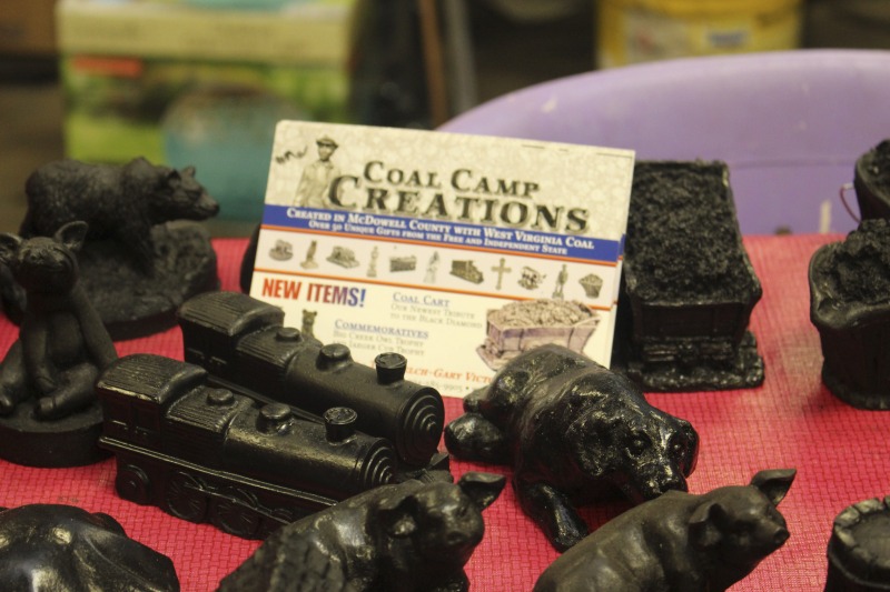 Coal Camp Creations is a workshop in Kimball, WV in McDowell County, sharing space and run by the non-profit arts organization McArts. Workers at Coal Camp Creations, some of whom are former coal miners, create figurines and other objects from coal dust and sell them to visitors. McArts was founded by Jean Battlo and three other artists in 1979. Battlo now serves as the organizations creative director.