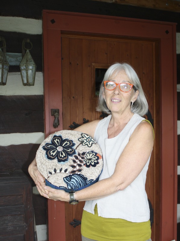 ["Susan Feller, 63 at the time of this interview, lives in Hampshire County, West Virginia with her partner Jim in the log home they built. With a degree in Art and History from UMass/Boston and a life-long interest in handwork craft, she learned to rug hook in 1994, a medium allowing her to paint with wool. This skill was the entry into the niche market of rug hookingdesigning patterns, selling hand-dyed wool, and teaching as far away as Australia, throughout the US and Canada. These days, Feller works in her studio creating fiber art for the walls. Juried as a Tamarack gallery artist, and a recipient of a purchase award from the WV Division of Culture and History, she serves on the Board of Directors for Tamarack Foundation for the Arts and The River House board in Capon Bridge, networking with and advocating for artists in the state and beyond.Read her piece on the West Virginia Folklife blog about the McDonald sisters: https://wvfolklife.org/2018/05/15/textile-artist-susan-feller-on-the-mcdonald-sisters-of-gilmer-county/Susan Fellers website: https://artwools.com/"]%