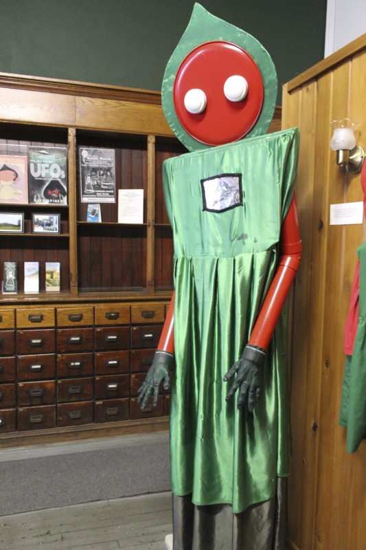 ["The Flatwoods Monster Museum, which also serves as the Braxton County Visitors Center, is located in downtown Sutton in Braxton County, West Virginia. The Museum displays ephemera, folk art, videos, and souvenirs related to the legend of the Flatwoods Monster, which was first sighted in Flatwoods, West Virginia on September 12, 1952 by Kathleen May, Eugene Lemon, Teddy May, Ronald Shaver, Neal Nunley, Teddy Neal, and Tommy Hyer. West Virginia Humanities Council Executive Director Eric Waggoner and State Folklorist Emily Hilliard visited the museum and met with Andrew Smith, Executive Director of the Braxton County CVB and Flatwoods Monster Museum, on January 30, 2020.Visit the Flatwoods Museum website here: https://braxtonwv.org/the-flatwoods-monster/visit-the-museum/For more on the legend of the Flatwoods Monster, visit e-WV: https://www.wvencyclopedia.org/articles/2192"]%