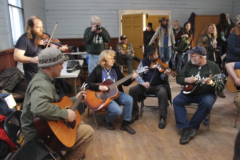 ["Every year on the Saturday before Ash Wednesday, the town of Helvetia in Randolph County, West Virginia, hosts its Fasnacht celebration, a pre-Lenten mountain Mardi Gras intended both to reinforce Swiss customs for locals and bring much-needed tourist dollars to the town in the sparse mid-winter months.Though the holiday was originally celebrated only by locals in the towns private homes, in the late 1960s, town matriarch Eleanor Mailloux restored the holiday as a public celebration. Today, Fasnacht attracts attendees from near and far. The event begins with an open music jam at the Helvetia Star Band Hall or a special sampler plate dinner from the Hutte Restaurant. Then everyone gathers in the Star Band Hall in their homemade papier-mache masks for a masked lampion parade to the Community Hall. At the second hall, there is a mask contest for kids, a square dance called by local callers and accompanied by the Helvetia Star Band, and a treat table of traditional doughnuts and Swiss rosettes and hozablatz made by Diane Betler, Eleanor Betler, and other local bakers. All of this takes place under an effigy of Old Man Winter, hanging over the dance floor. At midnight the Old Man is cut from the rafters and burned on the bonfire outside, as the crowd sings a rousing a capella rendition of Country Roads. Learn more in Emily Hilliard's Bitter Southerner piece on Helvetia's seasonal celebrations, including Fasnacht: https://bittersoutherner.com/my-year-in-helvetia-west-virginiaAnd her piece on Fasnachts foodways traditions on NPRs The Salt: https://www.npr.org/sections/thesalt/2015/02/17/386970143/swiss-village-west-virginia-mardi-gras-feast-fasnacht Also see the Helvetia Foodways Oral History Project conducted by the West Virginia Folklife Program in partnership with the Southern Foodways Alliance: https://www.southernfoodways.org/oral-history/helvetia-west-virginia/"]%