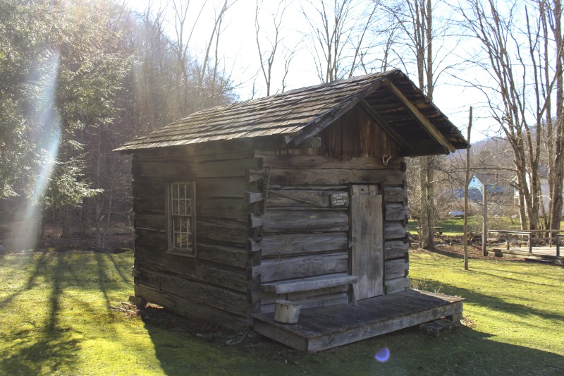 exterior-of-first-settler-s-cabin-with-original-old-furniture-in