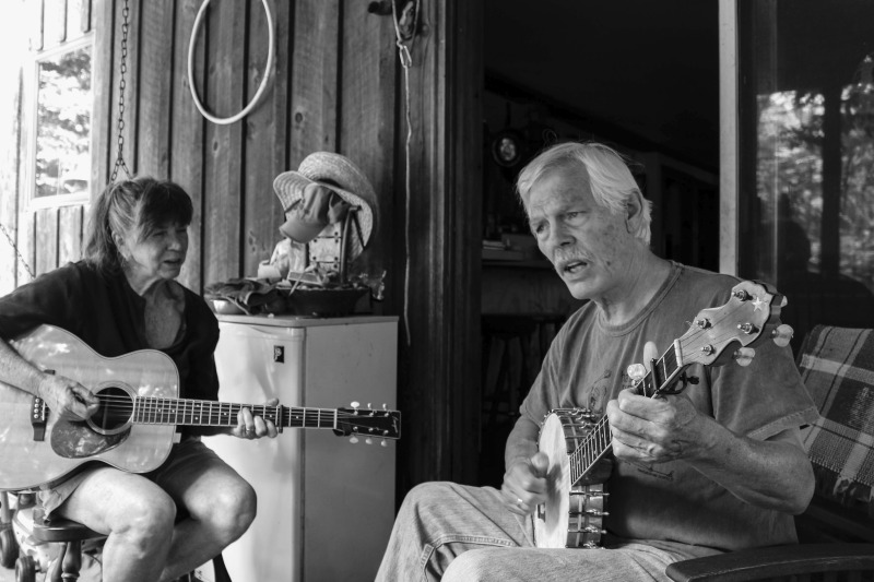 Sam & Joe HerrmannJoe Herrmann (b.1949) and Sam Herrmann (b. 1949), both Maryland natives, are traditional musicians who play together as part of Critton Hollow String Band. They have been a couple since the mid-1970s when they moved to Hampshire County, West Virginia. Joe is a fiddle and banjo player, and Sam is a guitar and hammer dulcimer player. Sam is also a knitter, hand yarn spinner, and owns the knitting kit company Samspun. They live on a piece of land in Paw Paw, WV where they keep sheep.