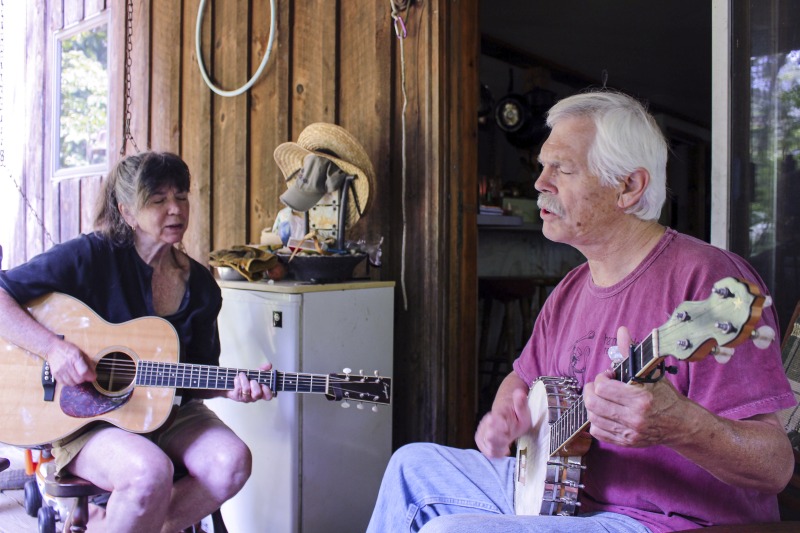 Joe Herrmann (b.1949) and Sam Herrmann (b. 1949), both Maryland natives, are traditional musicians who play together as part of Critton Hollow String Band. They have been a couple since the mid-1970s when they moved to Hampshire County, West Virginia. Joe is a fiddle and banjo player, and Sam is a guitar and hammer dulcimer player. Sam is also a knitter, hand yarn spinner, and owns the knitting kit company Samspun. They live on a piece of land in Paw Paw, WV where they keep sheep.