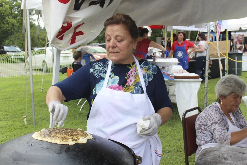 ["Wheelings Our Lady of Lebanon Maronite Catholic Church has been hosting its annual Mahrajan Festival at Oglebay Park for over 85 years. The festival began in 1933 as a fundraiser to rebuild the church, which had been lost to fire the year prior. Activities at the Mahrajan festival include a vast spread of Lebanese food--including kibbee, tabbouli, stuffed grape leaves, hummus, saj bread, and various Lebanese cookies and desserts, a sale of handcrafted Lebanese items, live music, Lebanese dancing, and a liturgy.To learn more about Our Lady of Lebanon Maronite Catholic Church, visit their website: http://www.ololwv.com/Also see interviews with church elders Carol Dougherty and Nick Ghaphery in the West Virginia Folklife Collection. The Dougherty interview is excerpted here: https://wvfolklife.org/2017/02/23/field-notes-carol-dougherty/"]%