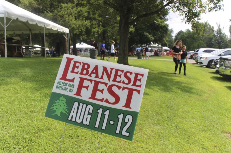 Wheelings Our Lady of Lebanon Maronite Catholic Church has been hosting its annual Mahrajan Festival at Oglebay Park for over 85 years. The festival began in 1933 as a fundraiser to rebuild the church, which had been lost to fire the year prior. Activities at the Mahrajan festival include a vast spread of Lebanese food--including kibbee, tabbouli, stuffed grape leaves, hummus, saj bread, and various Lebanese cookies and desserts, a sale of handcrafted Lebanese items, live music, Lebanese dancing, and a liturgy.To learn more about Our Lady of Lebanon Maronite Catholic Church, visit their website: http://www.ololwv.com/Also see interviews with church elders Carol Dougherty and Nick Ghaphery in the West Virginia Folklife Collection. The Dougherty interview is excerpted here: https://wvfolklife.org/2017/02/23/field-notes-carol-dougherty/