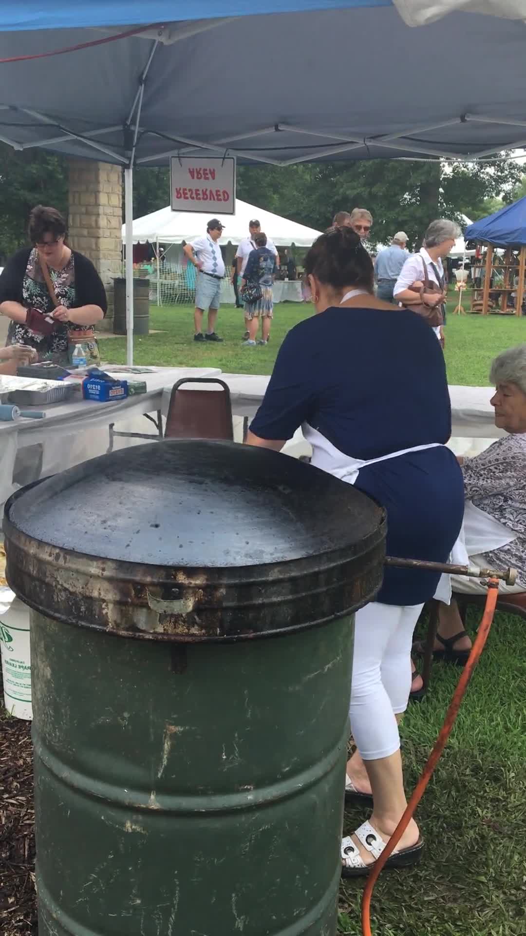 ["Wheelings Our Lady of Lebanon Maronite Catholic Church has been hosting its annual Mahrajan Festival at Oglebay Park for over 85 years. The festival began in 1933 as a fundraiser to rebuild the church, which had been lost to fire the year prior. Activities at the Mahrajan festival include a vast spread of Lebanese food--including kibbee, tabbouli, stuffed grape leaves, hummus, saj bread, and various Lebanese cookies and desserts, a sale of handcrafted Lebanese items, live music, Lebanese dancing, and a liturgy.To learn more about Our Lady of Lebanon Maronite Catholic Church, visit their website: http://www.ololwv.com/Also see interviews with church elders Carol Dougherty and Nick Ghaphery in the West Virginia Folklife Collection. The Dougherty interview is excerpted here: https://wvfolklife.org/2017/02/23/field-notes-carol-dougherty/"]%