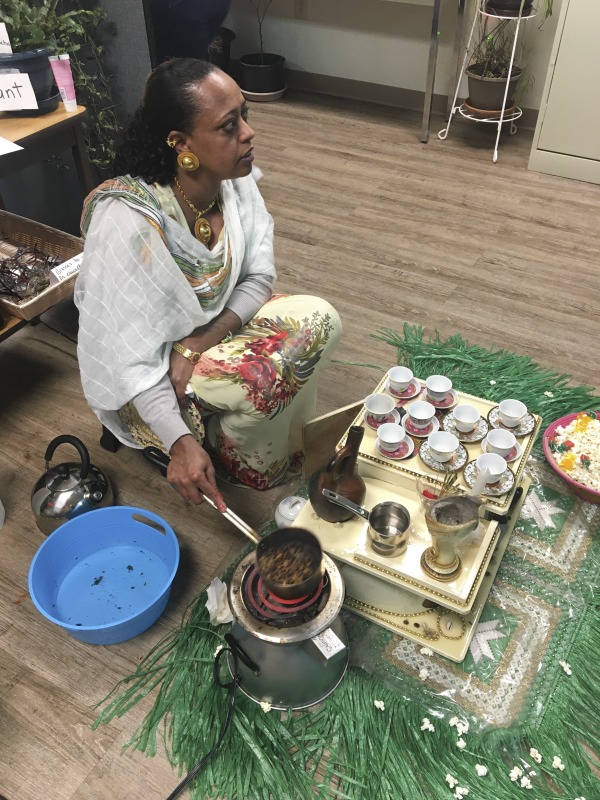 On February 25, 2020, Amy Loughs (b. 1975, Murray, Kentucky) Hardy County ESOL class in Moorefield hosted an Ethiopian/Eritrean coffee ceremony and potluck. Students, who are of Haitian, Burmese, Eritrean, Ethiopian, and Puerto Rican dissent brought in food dishes from their respective cultural traditions, to share with the class and state folklorist Emily Hilliard. The majority of the ESOL students work at Pilgrims Pride chicken plant in Moorefield. Dishes students brought to class include Mohinga, a Burmese soup with chili; a Burmese tea leaf salad; and Yuzana, a Burmese pickled tea; Ethiopian Doro Wat; Puerto Rican bread pudding; Haitian fried pork with gratin; and Himbasha, an Ethiopian bread with black sesame seeds or black cumin.