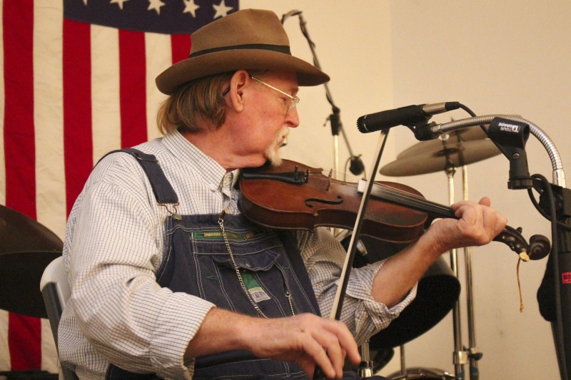 John D. Morris of Ivydale led an apprenticeship in old-time fiddle and stories of Clay County with Jen Iskow of Thomas as part of the 2018 West Virginia Folklife Apprenticeship Program, supported in part by the National Endowment for the Arts. John D. MorrisBorn in Ivydale, Clay County, into a family steeped in traditional music, David and John Morris learned from family and neighbors, including banjo player Jenes Cottrell and fiddler French Carpenter. After David returned from Vietnam in 1968, the brothers began organizing musical get-togethers and, in 1969, held the first Morris Family Old-Time Music Festival that same year. The festival became a major traditional music event in Clay County and filmmaker Bob Gates documented the 1972 festival in his film The Morris Family Old-Time Music Festival.Members of The Morris Brothers band included Pocahontas County old-time banjo player Dwight Diller and the late North Carolina harmonica player John Martin. Playing a mix of old-time, bluegrass, and country styles, including some of Davids original music, the group played together through the mid-70s, releasing an LP in the late 60s, Music As We Learned It, and two live shows on eight-track tapes. John, a traditional fiddler, and David, a singer, songwriter, and guitarist, were involved in union and environmental activities from the late 1960s through the 1970s. They were also instrumental in establishing the first Vandalia Gathering at the Cultural Center in 1977.The Morris Brothers music was featured in Barbara Kopples 1976 film Harlan County, USA. David, who passed away in 2016, contributed music to Kopples 2015 film about Vietnam vets, Shelter.John lives in Ivydale and plays fiddle at music events across West Virginia. He is a rich source of information about the history of old-time music in central West Virginia, and one of the few native fiddlers of his generation to continue the older style of playing.Morris was awarded the National Endowment for the Arts National Heritage Fellowship, the nations highest honor in the folk and traditional arts, in 2020.Jen IskowJen Iskow is an artist, designer, musician, and community organizer based in Thomas, West Virginia. Born and raised in Rockville, Maryland, Jen grew up learning to play blues and punk music. It wasnt until she moved to Morgantown in 2009 for college that she was introduced to old-time music at the weekly Brew Pub jam hosted by Stewed Mulligan. After graduating from West Virginia University, she finally settled in Elkins, West Virginia and accepted a position as the Marketing Coordinator for the Augusta Heritage Center. Suddenly being surrounded by so many talented traditional artists, Jen was immersed into the music and inspired to learn to play fiddle. After studying under talented fiddlers such as Scott Prouty, Erynn Marshall, Jesse Wells, Ben Townsend, John Harrod, and more, Jen met John Morris at his house in Ivydale, and the rest is historySee our feature on Morris apprenticeship with Iskow here: https://wvfolklife.org/2018/11/09/2018-master-artist-apprentice-feature-john-morris-jen-iskow-old-time-fiddling-and-stories-of-clay-county/