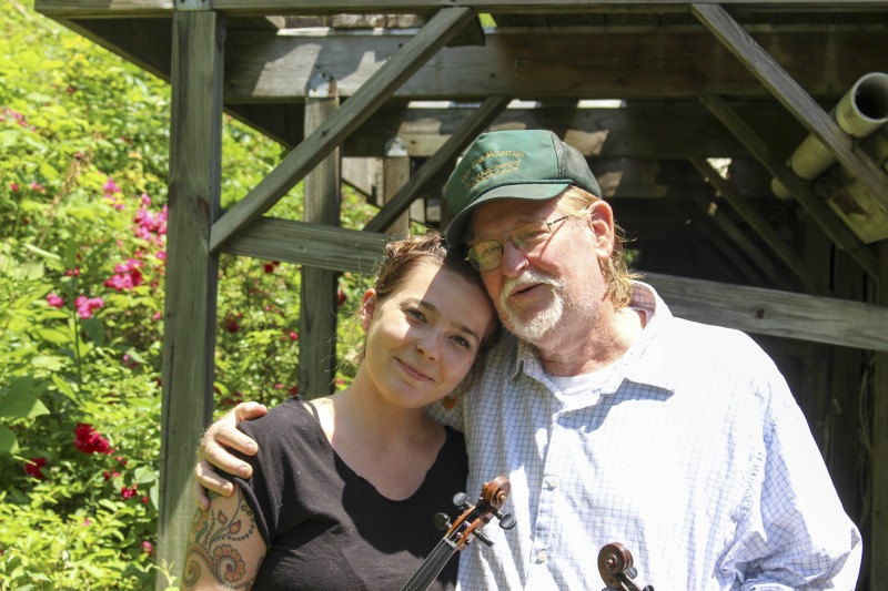 ["John D. Morris of Ivydale led an apprenticeship in old-time fiddle and stories of Clay County with Jen Iskow of Thomas as part of the 2018 West Virginia Folklife Apprenticeship Program, supported in part by the National Endowment for the Arts. John D. MorrisBorn in Ivydale, Clay County, into a family steeped in traditional music, David and John Morris learned from family and neighbors, including banjo player Jenes Cottrell and fiddler French Carpenter. After David returned from Vietnam in 1968, the brothers began organizing musical get-togethers and, in 1969, held the first Morris Family Old-Time Music Festival that same year. The festival became a major traditional music event in Clay County and filmmaker Bob Gates documented the 1972 festival in his film The Morris Family Old-Time Music Festival.Members of The Morris Brothers band included Pocahontas County old-time banjo player Dwight Diller and the late North Carolina harmonica player John Martin. Playing a mix of old-time, bluegrass, and country styles, including some of Davids original music, the group played together through the mid-70s, releasing an LP in the late 60s, Music As We Learned It, and two live shows on eight-track tapes. John, a traditional fiddler, and David, a singer, songwriter, and guitarist, were involved in union and environmental activities from the late 1960s through the 1970s. They were also instrumental in establishing the first Vandalia Gathering at the Cultural Center in 1977.The Morris Brothers music was featured in Barbara Kopples 1976 film Harlan County, USA. David, who passed away in 2016, contributed music to Kopples 2015 film about Vietnam vets, Shelter.John lives in Ivydale and plays fiddle at music events across West Virginia. He is a rich source of information about the history of old-time music in central West Virginia, and one of the few native fiddlers of his generation to continue the older style of playing.Morris was awarded the National Endowment for the Arts National Heritage Fellowship, the nations highest honor in the folk and traditional arts, in 2020.Jen IskowJen Iskow is an artist, designer, musician, and community organizer based in Thomas, West Virginia. Born and raised in Rockville, Maryland, Jen grew up learning to play blues and punk music. It wasnt until she moved to Morgantown in 2009 for college that she was introduced to old-time music at the weekly Brew Pub jam hosted by Stewed Mulligan. After graduating from West Virginia University, she finally settled in Elkins, West Virginia and accepted a position as the Marketing Coordinator for the Augusta Heritage Center. Suddenly being surrounded by so many talented traditional artists, Jen was immersed into the music and inspired to learn to play fiddle. After studying under talented fiddlers such as Scott Prouty, Erynn Marshall, Jesse Wells, Ben Townsend, John Harrod, and more, Jen met John Morris at his house in Ivydale, and the rest is historySee our feature on Morris apprenticeship with Iskow here: https://wvfolklife.org/2018/11/09/2018-master-artist-apprentice-feature-john-morris-jen-iskow-old-time-fiddling-and-stories-of-clay-county/"]%