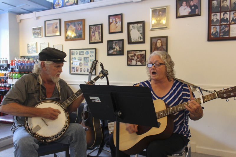 ["Elaine (Moore) Purkey is an activist songwriter and musician from Harts Creek, West Virginia in Lincoln County. She was born on May 29, 1949, on the same piece of property where she still lives. She was raised in a family of musicians and flatfoot dancers and attributes her powerful voice to the acapella singing she learned as a member of the Church of Christ. As a teenager she played in bands with her brother, and in early adulthood she was the lead singer of a local country band. In the 1980s, she began performing regularly on the Wallace Horn Friendly Neighbors Show, a live radio program out of Logan County that has been on the air since 1967. She now hosts the show. Elaine performed a concert at Yasou Greek Restaurant in McDowell County on July 8, 2017. The concert was sponsored by the West Virginia Folklife Program at the West Virginia Humanities Council and McArts."]%