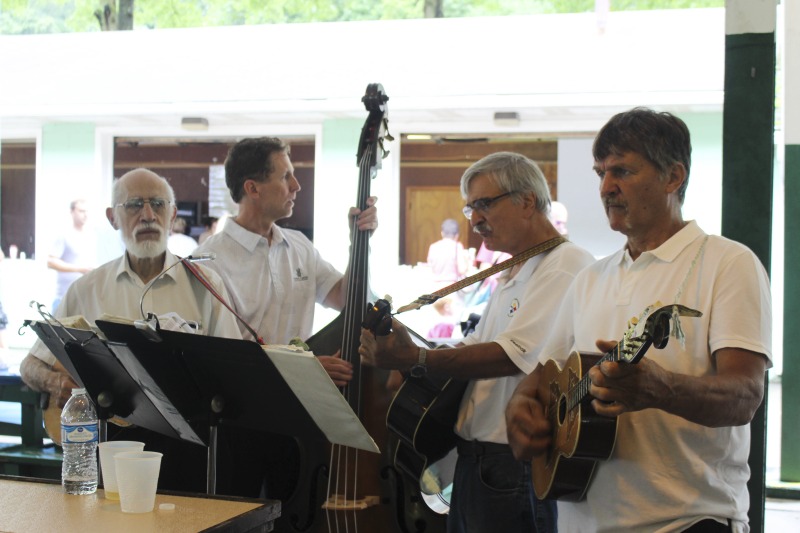 Every July, the Mens Club of the Steubenville, Ohio Holy Resurrection Serbian Orthodox Church hosts an annual picnic at their picnic grounds along Kings Creek in Weirton, West Virginia. The event serves as both a fundraiser for the Mens Club and a homecoming for Weirton and Steubenvilles Serbian Community. The event features Serbian music, dance, food, and drink. Mens Club members roast chickens and lambs on spits over open wood fires and sell them to picnic attendees. The spits were constructed out of material from Weirton Steel by Mens Club members and Weirton Steel employees in the 1960s. Other food served at the picnic includes pogacha (a type of Serbian bread), haluski or cabbage and noodles, cevaps (a pork, lamb, and beef sausage), strudel, nut rolls, beer, and Slivovitz.In 2017, state folklorist Emily Hilliard attended the Serbian picnic with Brynn Kusic, whose fathers family is part of the Weirton Serbian community. Learn more about the Annual Picnic via the Holy Resurrection Serbian Orthodox Church: https://www.hrsoc-steubenville.org/annual-picnicSee the short video and audio documentary about the Chicken Blasts, produced by the West Virginia Folklife Program and West Virginia Public Broadcasting: https://wvfolklife.org/2020/01/27/weirtons-serbian-heritage-is-a-chicken-blast/ https://www.youtube.com/watch?v=XpGF-MFUlhYhttps://soundcloud.com/wvpublicnews/weirtons-serbian-heritage-is-a-chicken-blast