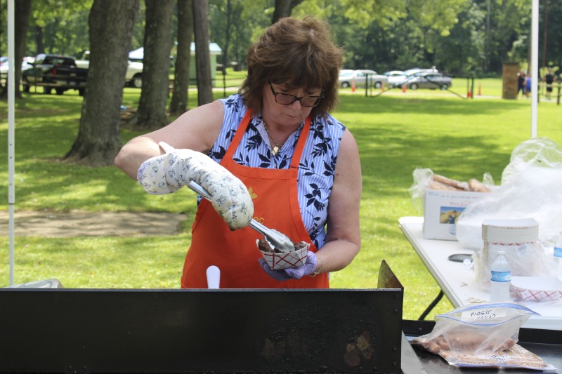 Every July, the Mens Club of the Steubenville, Ohio Holy Resurrection Serbian Orthodox Church hosts an annual picnic at their picnic grounds along Kings Creek in Weirton, West Virginia. The event serves as both a fundraiser for the Mens Club and a homecoming for Weirton and Steubenvilles Serbian Community. The event features Serbian music, dance, food, and drink. Mens Club members roast chickens and lambs on spits over open wood fires and sell them to picnic attendees. The spits were constructed out of material from Weirton Steel by Mens Club members and Weirton Steel employees in the 1960s. Other food served at the picnic includes pogacha (a type of Serbian bread), haluski or cabbage and noodles, cevaps (a pork, lamb, and beef sausage), strudel, nut rolls, beer, and Slivovitz.In 2017, state folklorist Emily Hilliard attended the Serbian picnic with Brynn Kusic, whose fathers family is part of the Weirton Serbian community. In 2019, Hilliard attended with a WVPB film crew to capture additional video footage and audio tape for a short video documentary (see below).Learn more about the Annual Picnic via the Holy Resurrection Serbian Orthodox Church: https://www.hrsoc-steubenville.org/annual-picnicSee the short video and audio documentary about the Chicken Blasts, produced by the West Virginia Folklife Program and West Virginia Public Broadcasting: https://wvfolklife.org/2020/01/27/weirtons-serbian-heritage-is-a-chicken-blast/ https://www.youtube.com/watch?v=XpGF-MFUlhYhttps://soundcloud.com/wvpublicnews/weirtons-serbian-heritage-is-a-chicken-blast