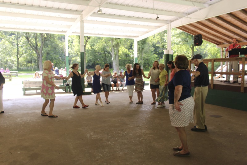 ["Every July, the Mens Club of the Steubenville, Ohio Holy Resurrection Serbian Orthodox Church hosts an annual picnic at their picnic grounds along Kings Creek in Weirton, West Virginia. The event serves as both a fundraiser for the Mens Club and a homecoming for Weirton and Steubenvilles Serbian Community. The event features Serbian music, dance, food, and drink. Mens Club members roast chickens and lambs on spits over open wood fires and sell them to picnic attendees. The spits were constructed out of material from Weirton Steel by Mens Club members and Weirton Steel employees in the 1960s. Other food served at the picnic includes pogacha (a type of Serbian bread), haluski or cabbage and noodles, cevaps (a pork, lamb, and beef sausage), strudel, nut rolls, beer, and Slivovitz.In 2017, state folklorist Emily Hilliard attended the Serbian picnic with Brynn Kusic, whose fathers family is part of the Weirton Serbian community. Learn more about the Annual Picnic via the Holy Resurrection Serbian Orthodox Church: https://www.hrsoc-steubenville.org/annual-picnicSee the short video and audio documentary about the Chicken Blasts, produced by the West Virginia Folklife Program and West Virginia Public Broadcasting: https://wvfolklife.org/2020/01/27/weirtons-serbian-heritage-is-a-chicken-blast/https://www.youtube.com/watch?v=XpGF-MFUlhYhttps://soundcloud.com/wvpublicnews/weirtons-serbian-heritage-is-a-chicken-blast"]%