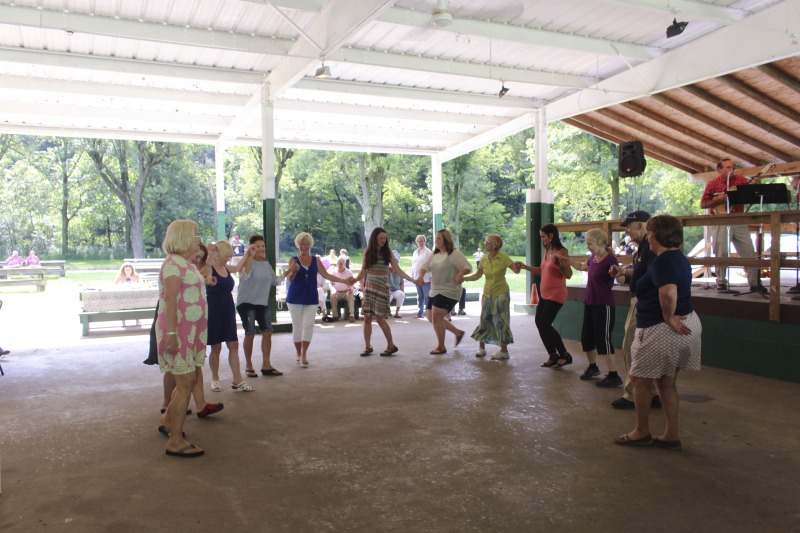 Every July, the Mens Club of the Steubenville, Ohio Holy Resurrection Serbian Orthodox Church hosts an annual picnic at their picnic grounds along Kings Creek in Weirton, West Virginia. The event serves as both a fundraiser for the Mens Club and a homecoming for Weirton and Steubenvilles Serbian Community. The event features Serbian music, dance, food, and drink. Mens Club members roast chickens and lambs on spits over open wood fires and sell them to picnic attendees. The spits were constructed out of material from Weirton Steel by Mens Club members and Weirton Steel employees in the 1960s. Other food served at the picnic includes pogacha (a type of Serbian bread), haluski or cabbage and noodles, cevaps (a pork, lamb, and beef sausage), strudel, nut rolls, beer, and Slivovitz.In 2017, state folklorist Emily Hilliard attended the Serbian picnic with Brynn Kusic, whose fathers family is part of the Weirton Serbian community. Learn more about the Annual Picnic via the Holy Resurrection Serbian Orthodox Church: https://www.hrsoc-steubenville.org/annual-picnicSee the short video and audio documentary about the Chicken Blasts, produced by the West Virginia Folklife Program and West Virginia Public Broadcasting: https://wvfolklife.org/2020/01/27/weirtons-serbian-heritage-is-a-chicken-blast/https://www.youtube.com/watch?v=XpGF-MFUlhYhttps://soundcloud.com/wvpublicnews/weirtons-serbian-heritage-is-a-chicken-blast