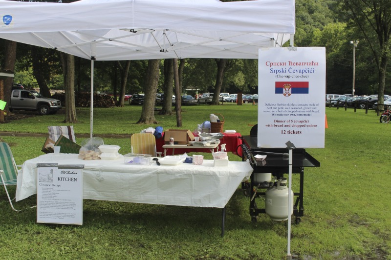 ["Every July, the Mens Club of the Steubenville, Ohio Holy Resurrection Serbian Orthodox Church hosts an annual picnic at their picnic grounds along Kings Creek in Weirton, West Virginia. The event serves as both a fundraiser for the Mens Club and a homecoming for Weirton and Steubenvilles Serbian Community. The event features Serbian music, dance, food, and drink. Mens Club members roast chickens and lambs on spits over open wood fires and sell them to picnic attendees. The spits were constructed out of material from Weirton Steel by Mens Club members and Weirton Steel employees in the 1960s. Other food served at the picnic includes pogacha (a type of Serbian bread), haluski or cabbage and noodles, cevaps (a pork, lamb, and beef sausage), strudel, nut rolls, beer, and Slivovitz.In 2017, state folklorist Emily Hilliard attended the Serbian picnic with Brynn Kusic, whose fathers family is part of the Weirton Serbian community. Learn more about the Annual Picnic via the Holy Resurrection Serbian Orthodox Church: https://www.hrsoc-steubenville.org/annual-picnicSee the short video and audio documentary about the Chicken Blasts, produced by the West Virginia Folklife Program and West Virginia Public Broadcasting: https://wvfolklife.org/2020/01/27/weirtons-serbian-heritage-is-a-chicken-blast/https://www.youtube.com/watch?v=XpGF-MFUlhYhttps://soundcloud.com/wvpublicnews/weirtons-serbian-heritage-is-a-chicken-blast"]%