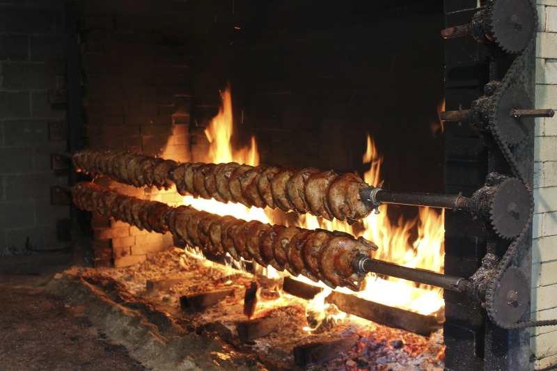 ["Every summer Wednesday since 1969, members of the Serbian Eastern Orthodox Church Mens Club have hosted a Chicken Blast at the Serbian Picnic Grounds along Kings Creek outside of Weirton, West Virginia. They roast 300-400 chickens per week as a fundraiser for the maintenance of the picnic grounds. The spits, an industrial brick oven, and walk-in coolers were constructed in the 1960s out of material from Weirton Steel by Mens Club members, most of whom were Weirton Steel employees. Each week, the choir also sells pogacha (a type of Serbian bread), haluski or cabbage and noodles, corn on the cob, strudel and other desserts. The bar at the picnic grounds is also open, serving beer and Slivovitz.See the short video and audio documentary about the Chicken Blasts, produced by the West Virginia Folklife Program and West Virginia Public Broadcasting: https://wvfolklife.org/2020/01/27/weirtons-serbian-heritage-is-a-chicken-blast/ https://www.youtube.com/watch?v=XpGF-MFUlhYhttps://soundcloud.com/wvpublicnews/weirtons-serbian-heritage-is-a-chicken-blast"]%