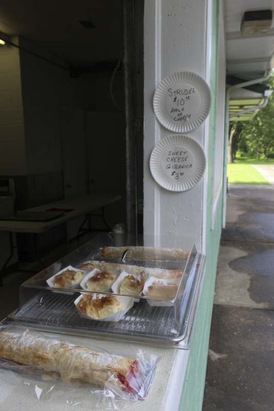 ["Every summer Wednesday since 1969, members of the Serbian Eastern Orthodox Church Mens Club have hosted a Chicken Blast at the Serbian Picnic Grounds along Kings Creek outside of Weirton, West Virginia. They roast 300-400 chickens per week as a fundraiser for the maintenance of the picnic grounds. The spits, an industrial brick oven, and walk-in coolers were constructed in the 1960s out of material from Weirton Steel by Mens Club members, most of whom were Weirton Steel employees. Each week, the choir also sells pogacha (a type of Serbian bread), haluski or cabbage and noodles, corn on the cob, strudel and other desserts. The bar at the picnic grounds is also open, serving beer and Slivovitz.See the short video and audio documentary about the Chicken Blasts, produced by the West Virginia Folklife Program and West Virginia Public Broadcasting: https://wvfolklife.org/2020/01/27/weirtons-serbian-heritage-is-a-chicken-blast/ https://www.youtube.com/watch?v=XpGF-MFUlhYhttps://soundcloud.com/wvpublicnews/weirtons-serbian-heritage-is-a-chicken-blast"]%