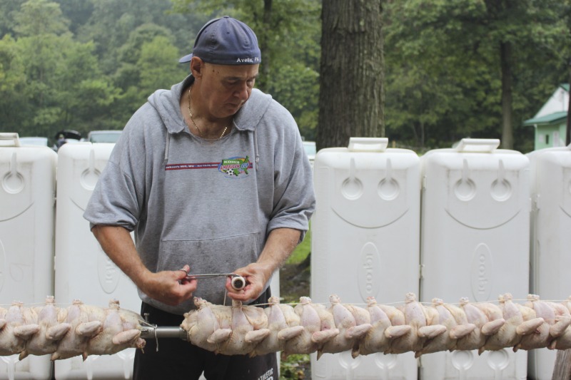 Every summer Wednesday since 1969, members of the Serbian Eastern Orthodox Church Mens Club have hosted a Chicken Blast at the Serbian Picnic Grounds along Kings Creek outside of Weirton, West Virginia. They roast 300-400 chickens per week as a fundraiser for the maintenance of the picnic grounds. The spits, an industrial brick oven, and walk-in coolers were constructed in the 1960s out of material from Weirton Steel by Mens Club members, most of whom were Weirton Steel employees. Each week, the choir also sells pogacha (a type of Serbian bread), haluski or cabbage and noodles, corn on the cob, strudel and other desserts. The bar at the picnic grounds is also open, serving beer and Slivovitz.See the short video and audio documentary about the Chicken Blasts, produced by the West Virginia Folklife Program and West Virginia Public Broadcasting: https://wvfolklife.org/2020/01/27/weirtons-serbian-heritage-is-a-chicken-blast/ https://www.youtube.com/watch?v=XpGF-MFUlhYhttps://soundcloud.com/wvpublicnews/weirtons-serbian-heritage-is-a-chicken-blast