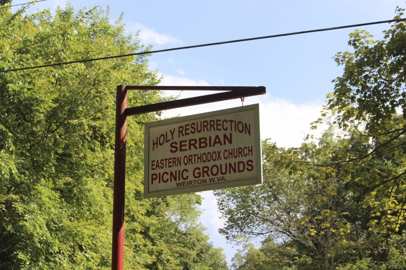 ["Every summer Wednesday since 1969, members of the Serbian Eastern Orthodox Church Mens Club have hosted a Chicken Blast at the Serbian Picnic Grounds along Kings Creek outside of Weirton, West Virginia. They roast 300-400 chickens per week as a fundraiser for the maintenance of the picnic grounds. The spits, an industrial brick oven, and walk-in coolers were constructed in the 1960s out of material from Weirton Steel by Mens Club members, most of whom were Weirton Steel employees. Each week, the choir also sells pogacha (a type of Serbian bread), haluski or cabbage and noodles, corn on the cob, strudel and other desserts. The bar at the picnic grounds is also open, serving beer and Slivovitz.See the short video and audio documentary about the Chicken Blasts, produced by the West Virginia Folklife Program and West Virginia Public Broadcasting: https://wvfolklife.org/2020/01/27/weirtons-serbian-heritage-is-a-chicken-blast/ https://www.youtube.com/watch?v=XpGF-MFUlhYhttps://soundcloud.com/wvpublicnews/weirtons-serbian-heritage-is-a-chicken-blast"]%