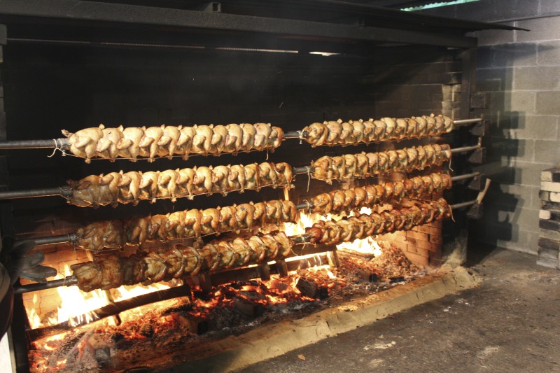 ["Every summer Wednesday since 1969, members of the Serbian Eastern Orthodox Church Mens Club have hosted a Chicken Blast at the Serbian Picnic Grounds along Kings Creek outside of Weirton, West Virginia. They roast 300-400 chickens per week as a fundraiser for the maintenance of the picnic grounds. The spits, an industrial brick oven, and walk-in coolers were constructed in the 1960s out of material from Weirton Steel by Mens Club members, most of whom were Weirton Steel employees. Each week, the choir also sells pogacha (a type of Serbian bread), haluski or cabbage and noodles, corn on the cob, strudel and other desserts. The bar at the picnic grounds is also open, serving beer and Slivovitz.See the short video and audio documentary about the Chicken Blasts, produced by the West Virginia Folklife Program and West Virginia Public Broadcasting: https://wvfolklife.org/2020/01/27/weirtons-serbian-heritage-is-a-chicken-blast/ https://www.youtube.com/watch?v=XpGF-MFUlhYhttps://soundcloud.com/wvpublicnews/weirtons-serbian-heritage-is-a-chicken-blast"]%