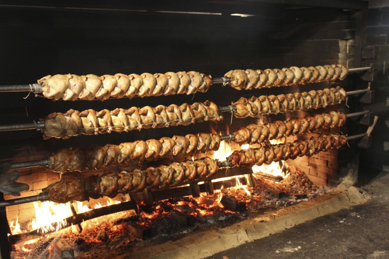 ["Every summer Wednesday since 1969, members of the Serbian Eastern Orthodox Church Mens Club have hosted a Chicken Blast at the Serbian Picnic Grounds along Kings Creek outside of Weirton, West Virginia. They roast 300-400 chickens per week as a fundraiser for the maintenance of the picnic grounds. The spits, an industrial brick oven, and walk-in coolers were constructed in the 1960s out of material from Weirton Steel by Mens Club members, most of whom were Weirton Steel employees. Each week, the choir also sells pogacha (a type of Serbian bread), haluski or cabbage and noodles, corn on the cob, strudel and other desserts. The bar at the picnic grounds is also open, serving beer and Slivovitz.See the short video and audio documentary about the Chicken Blasts, produced by the West Virginia Folklife Program and West Virginia Public Broadcasting: https://wvfolklife.org/2020/01/27/weirtons-serbian-heritage-is-a-chicken-blast/ https://www.youtube.com/watch?v=XpGF-MFUlhYhttps://soundcloud.com/wvpublicnews/weirtons-serbian-heritage-is-a-chicken-blast"]%