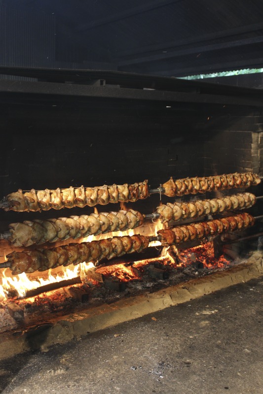 ["Every summer Wednesday since 1969, members of the Serbian Eastern Orthodox Church Mens Club have hosted a Chicken Blast at the Serbian Picnic Grounds along Kings Creek outside of Weirton, West Virginia. They roast 300-400 chickens per week as a fundraiser for the maintenance of the picnic grounds. The spits, an industrial brick oven, and walk-in coolers were constructed in the 1960s out of material from Weirton Steel by Mens Club members, most of whom were Weirton Steel employees. Each week, the choir also sells pogacha (a type of Serbian bread), haluski or cabbage and noodles, corn on the cob, strudel and other desserts. The bar at the picnic grounds is also open, serving beer and Slivovitz.See the short video and audio documentary about the Chicken Blasts, produced by the West Virginia Folklife Program and West Virginia Public Broadcasting: https://wvfolklife.org/2020/01/27/weirtons-serbian-heritage-is-a-chicken-blast/ https://www.youtube.com/watch?v=XpGF-MFUlhYhttps://soundcloud.com/wvpublicnews/weirtons-serbian-heritage-is-a-chicken-blast"]%