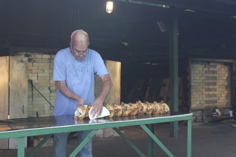 ["Every summer Wednesday since 1969, members of the Serbian Eastern Orthodox Church Mens Club have hosted a Chicken Blast at the Serbian Picnic Grounds along Kings Creek outside of Weirton, West Virginia. They roast 300-400 chickens per week as a fundraiser for the maintenance of the picnic grounds. The spits, an industrial brick oven, and walk-in coolers were constructed in the 1960s out of material from Weirton Steel by Mens Club members, most of whom were Weirton Steel employees. Each week, the choir also sells pogacha (a type of Serbian bread), haluski or cabbage and noodles, corn on the cob, strudel and other desserts. The bar at the picnic grounds is also open, serving beer and Slivovitz.See the short video and audio documentary about the Chicken Blasts, produced by the West Virginia Folklife Program and West Virginia Public Broadcasting: https://wvfolklife.org/2020/01/27/weirtons-serbian-heritage-is-a-chicken-blast/ https://www.youtube.com/watch?v=XpGF-MFUlhYhttps://soundcloud.com/wvpublicnews/weirtons-serbian-heritage-is-a-chicken-blast"]%