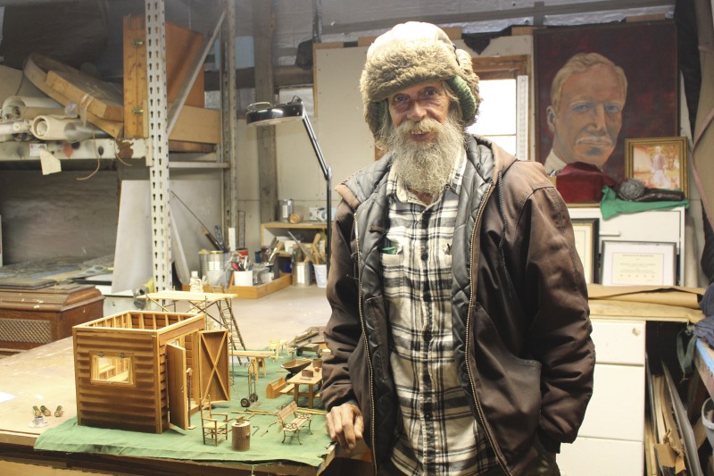 ["Benjamin (Benny) D. Snyder, 60, is a miniatures maker, woodcarver, and poultry farmer living at The Folly farm outside of Shepherdstown, WV. He makes miniatures on a 1/12th dollhouse scale of objects in his environment such as wheelbarrows, tools, scaffolding, tool sheds, park benches, watering cans, and more. He is a native of Weirton, WV and a U.S. Army veteran."]%