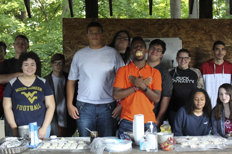 ["On September 21, 2017, old-time musician and writer Pete Koskys Appalachian Studies class at South Charleston High School made biscuits in a cast iron Dutch oven over a charcoal fire at the ROTC picnic shelter on the school campus. Kosky invited state folklorist Emily Hilliard to the class."]%