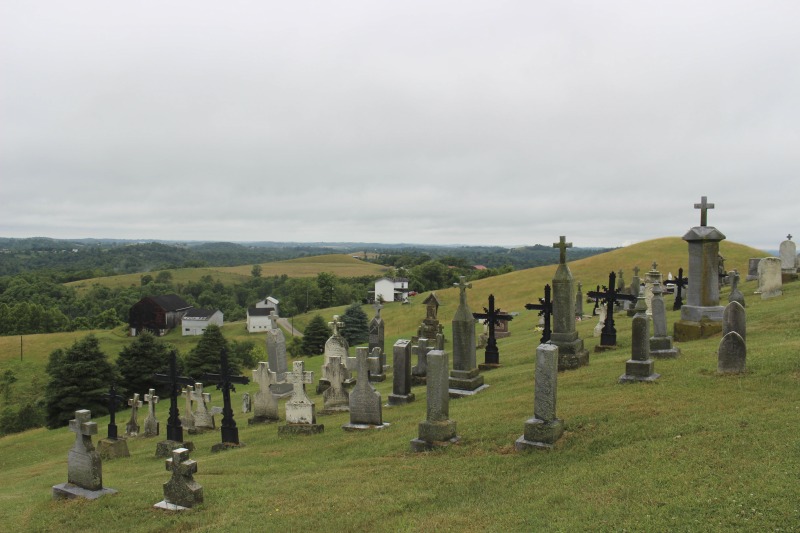 ["St. Joseph Settlement aka the German Settlement is a rural community of farms on the Marshall-Wetzel County borders, settled by German Catholic immigrants in the 1850s. As Cheryl Harshman says in her e-WV article on the settlement, the church, schoolhouse (now a public library and parish museum), rectory, community building, and cemetery are still the heart of the St. Joseph community.On June 22, 2016, Harshman hosted state folklorist Emily Hilliard on a visit to the settlement, meeting community members Jim and Debbie Frohnapfel and Ray Esteep and visiting the church and cemetery.Learn more via e-WV: https://www.wvencyclopedia.org/articles/158"]%