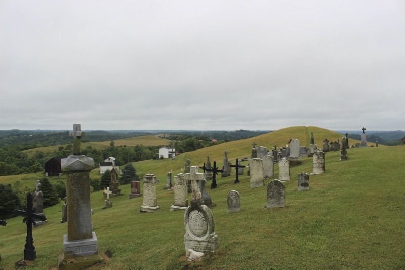 ["St. Joseph Settlement aka the German Settlement is a rural community of farms on the Marshall-Wetzel County borders, settled by German Catholic immigrants in the 1850s. As Cheryl Harshman says in her e-WV article on the settlement, the church, schoolhouse (now a public library and parish museum), rectory, community building, and cemetery are still the heart of the St. Joseph community.On June 22, 2016, Harshman hosted state folklorist Emily Hilliard on a visit to the settlement, meeting community members Jim and Debbie Frohnapfel and Ray Esteep and visiting the church and cemetery.Learn more via e-WV: https://www.wvencyclopedia.org/articles/158"]%