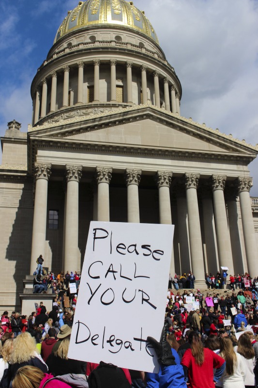 ["On February 22, 2018, thousands of West Virginia public school teachers and school service employees walked out of their classrooms in what would become a nine-day statewide strike. Teachers demands included a 5% raise and affordable healthcare coverage through the West Virginia Public Employees Insurance Agency or PEIA. These photos are part of a series of photos, videos, and interviews documenting the labor lore and expressive culture of the 2018 and 2019 West Virginia Teachers Strike.For more information on the 2018 and 2019 West Virginia Teachers Strike visit e-WV: https://www.wvencyclopedia.org/articles/2454"]%