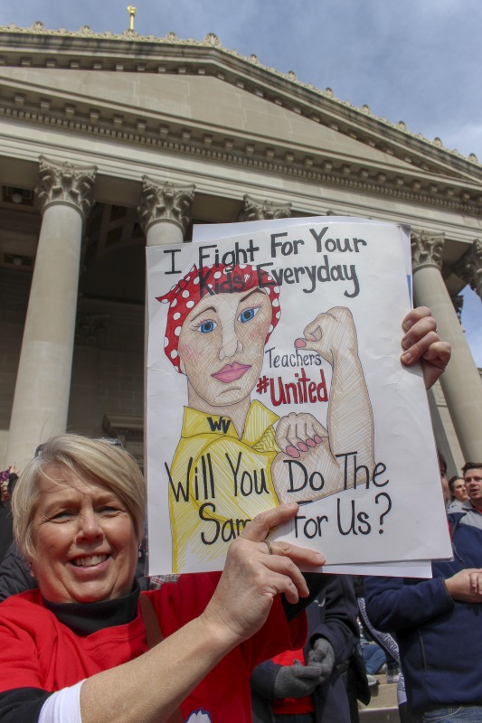 ["On February 22, 2018, thousands of West Virginia public school teachers and school service employees walked out of their classrooms in what would become a nine-day statewide strike. Teachers demands included a 5% raise and affordable healthcare coverage through the West Virginia Public Employees Insurance Agency or PEIA. These photos are part of a series of photos, videos, and interviews documenting the labor lore and expressive culture of the 2018 and 2019 West Virginia Teachers Strike.For more information on the 2018 and 2019 West Virginia Teachers Strike visit e-WV: https://www.wvencyclopedia.org/articles/2454"]%