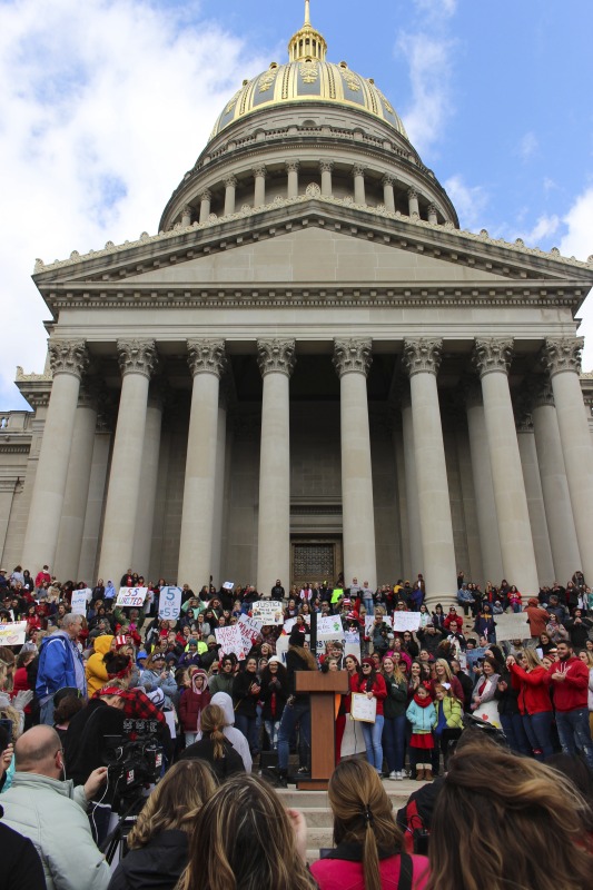 ["On February 22, 2018, thousands of West Virginia public school teachers and school service employees walked out of their classrooms in what would become a nine-day statewide strike. Teachers demands included a 5% raise and affordable healthcare coverage through the West Virginia Public Employees Insurance Agency or PEIA. These photos are part of a series of photos, videos, and interviews documenting the labor lore and expressive culture of the 2018 and 2019 West Virginia Teachers Strike.For more information on the 2018 and 2019 West Virginia Teachers Strike visit e-WV: https://www.wvencyclopedia.org/articles/2454"]%