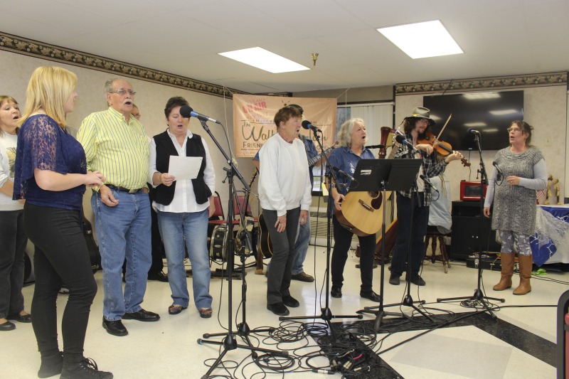 ["The Wallace Horn Friendly Neighbors Show is a live radio program, recorded in Logan County, and airing for over 50 years on WVOW, The Voice of the Coalfields. Wallace Horn founded the show and passed the creative directorship on to Elaine Purkey. This taping of the Friendly Neighbors Show, on November 18, 2017, was recorded at the Chapmanville Towers in Chapmanville, WV. Other taping locations include the Hot Cup coffee shop in Logan. Shows are taped twice a month."]%