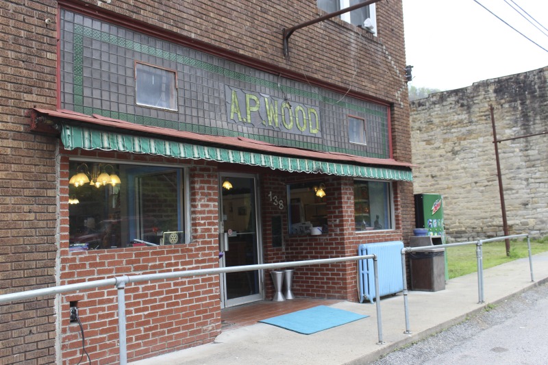 Yasou Restaurant is a Greek restaurant and grocery in Kimball in McDowell County. The restaurant has been owned and operated since 2003 by Markella Gianato whose maternal grandfather John Genadopoulus and father Adamantios Tommy Balasis opened The West Virginia Grocery in the same location in 1947. Genadopolous bought the building from A.P. Wood, whose name still remains on the storefront. The Grocery shut down in 2001 after the July flood all but destroyed the building.Today the restaurant serves as a hub in the Kimball community. Menu offerings include gyros, Greek-style spaghetti and meatballs, spanakopita, Greek salad, pastitsio (a Greek pasta with meat and bchamel), dolmades (stuffed grape leaves), and saganaki (pan-seared Greek cheese).State folklorist Emily Hilliard interviewed Gianato about her family history, foodways, and the business on April 27, 2016, but the interview was lost when Folklife Program equipment was stolen. Gianatos Our History statement on the Yasou website:On February 7, 1947, the Greek-American families of John Genadopoulos and Adamantios Tommy Balasis and Mary Balasis purchased the A.P. Wood Grocery.  Though the store was renamed the West Virginia Grocery, the name A.P. Wood remains etched in beautiful stained glass over the door at present day YaSou. From that time until the devasting flood of July 2001, the family kept the grocery in operation.  Ten months later, a second major flood hit the town within days of the business being reopened.  Despite this major setback, we were determined to move forward and reopen the business. Having my own restaurant was a lifelong dream, and on February 7, 2003, with the help of my mother Mary Balasis, my brothers John and Mathew, my husband Jimmy Joe, my son Adam, my mother-in-law Mary Verduce Gianato and the Grace of God, that dream became a reality with the opening of YaSou Restaurant.   I am immensely proud of the success that I have achieved.  I offer home-cooked meals, daily specials, and Greek cuisine along with many sandwich choices.  Most of the recipes I have used have been handed down to me from my mother and grandmother.  My love for the restaurant business came from my first job at the Virginian Restaurant in Pearisburg, Virginia, working under the guiding hands of, in my opinion, two of the greatest chefs, uncles and mentors, Mike and George Genadopoulos.  It was my days at the Virginian that made me realize I would someday like to become a great chef.  I strive for this every day. This has allowed me to meet many wonderful people who have stopped in along the way, as well as many local regulars who come in and make my day complete.  We hope to serve you for many years to come. Everyone that comes here, even for one time, becomes a part of the labyrinth of my life and will always be part of the memories here.  I want my guests to feel at home and comfortable when that are here.  If you have any concerns or requests, please feel free to ask.                                                             ---MarkellaRead more on the Yasou website: https://yasourestaurant-restaurant.business.site/