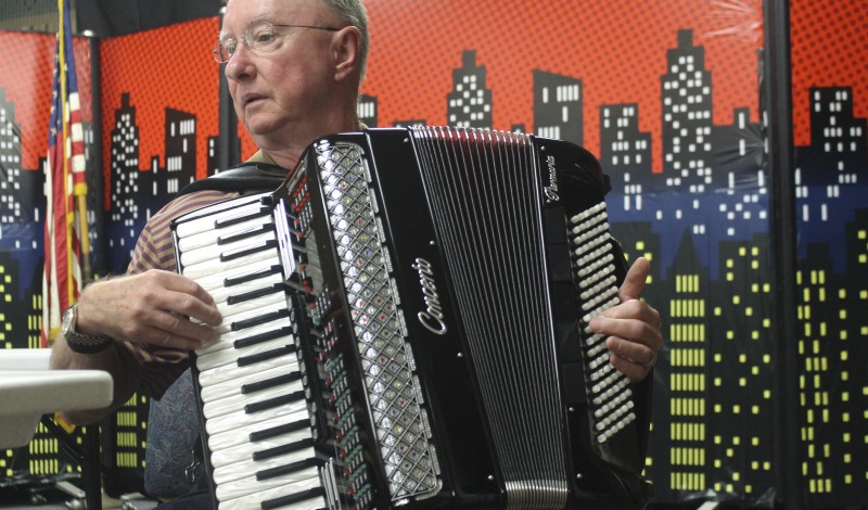 Thomas W. Zielinsky is a member of Weirton, West Virginias Polish community. He is a member of Sacred Heart of Mary Church in Weirton, WV, where he plays accordion at their annual Polish Festival and biannual Polka Mass. Photo made at the Mary H. Weir public library in Weirton.