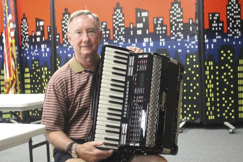 Thomas W. Zielinsky is a member of Weirton, West Virginias Polish community. He is a member of Sacred Heart of Mary Church in Weirton, WV, where he plays accordion at their annual Polish Festival and biannual Polka Mass. Photo made at the Mary H. Weir public library in Weirton.