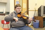 ["Trevor Hammons is a 17-year old banjo player and fiddler from Pocahontas County, and a member of the legendary musical Hammons Family. He is the only member of the Hammons Family who still actively plays music in the familys old-time tradition."]