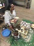 ["On February 25, 2020, Amy Loughs (b. 1975, Murray, Kentucky) Hardy County ESOL class in Moorefield hosted an Ethiopian/Eritrean coffee ceremony and potluck. Students, who are of Haitian, Burmese, Eritrean, Ethiopian, and Puerto Rican dissent brought in food dishes from their respective cultural traditions, to share with the class and state folklorist Emily Hilliard. The majority of the ESOL students work at Pilgrims Pride chicken plant in Moorefield. Dishes students brought to class include Mohinga, a Burmese soup with chili; a Burmese tea leaf salad; and Yuzana, a Burmese pickled tea; Ethiopian Doro Wat; Puerto Rican bread pudding; Haitian fried pork with gratin; and Himbasha, an Ethiopian bread with black sesame seeds or black cumin."]