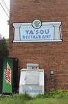 ["Yasou Restaurant is a Greek restaurant and grocery in Kimball in McDowell County. The restaurant has been owned and operated since 2003 by Markella Gianato whose maternal grandfather John Genadopoulus and father Adamantios Tommy Balasis opened The West Virginia Grocery in the same location in 1947. Genadopolous bought the building from A.P. Wood, whose name still remains on the storefront. The Grocery shut down in 2001 after the July flood all but destroyed the building.Today the restaurant serves as a hub in the Kimball community. Menu offerings include gyros, Greek-style spaghetti and meatballs, spanakopita, Greek salad, pastitsio (a Greek pasta with meat and bchamel), dolmades (stuffed grape leaves), and saganaki (pan-seared Greek cheese).State folklorist Emily Hilliard interviewed Gianato about her family history, foodways, and the business on April 27, 2016, but the interview was lost when Folklife Program equipment was stolen. Gianatos Our History statement on the Yasou website:On February 7, 1947, the Greek-American families of John Genadopoulos and Adamantios Tommy Balasis and Mary Balasis purchased the A.P. Wood Grocery.  Though the store was renamed the West Virginia Grocery, the name A.P. Wood remains etched in beautiful stained glass over the door at present day YaSou. From that time until the devasting flood of July 2001, the family kept the grocery in operation.  Ten months later, a second major flood hit the town within days of the business being reopened.  Despite this major setback, we were determined to move forward and reopen the business. Having my own restaurant was a lifelong dream, and on February 7, 2003, with the help of my mother Mary Balasis, my brothers John and Mathew, my husband Jimmy Joe, my son Adam, my mother-in-law Mary Verduce Gianato and the Grace of God, that dream became a reality with the opening of YaSou Restaurant.   I am immensely proud of the success that I have achieved.  I offer home-cooked meals, daily specials, and Greek cuisine along with many sandwich choices.  Most of the recipes I have used have been handed down to me from my mother and grandmother.  My love for the restaurant business came from my first job at the Virginian Restaurant in Pearisburg, Virginia, working under the guiding hands of, in my opinion, two of the greatest chefs, uncles and mentors, Mike and George Genadopoulos.  It was my days at the Virginian that made me realize I would someday like to become a great chef.  I strive for this every day. This has allowed me to meet many wonderful people who have stopped in along the way, as well as many local regulars who come in and make my day complete.  We hope to serve you for many years to come. Everyone that comes here, even for one time, becomes a part of the labyrinth of my life and will always be part of the memories here.  I want my guests to feel at home and comfortable when that are here.  If you have any concerns or requests, please feel free to ask.                                                             ---MarkellaRead more on the Yasou website: https://yasourestaurant-restaurant.business.site/"]